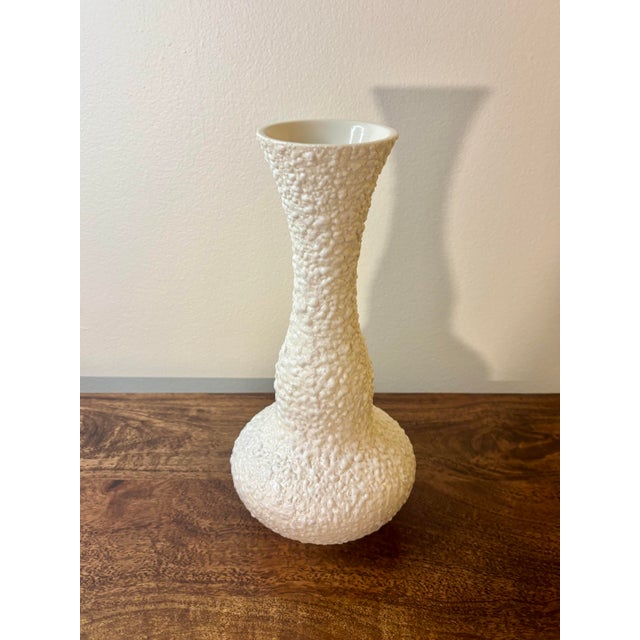 A striking mid-century modern ceramic vase by Royal Haeger, showcasing a sculptural flowing form and richly textured lava...
