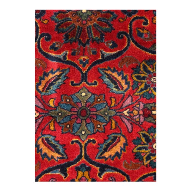 A lush array of spiraling vines, palmettes, and flowering plants repeats in rhythmic symmetry across the soft red field of...