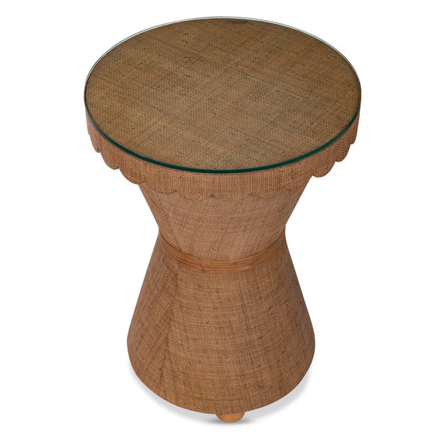 Graceful and textural, this raffia side table strikes a perfect balance between whimsy and refinement. The sculpted...