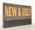 Reclaimed movie set sign made of aluminum on plastic foam board in yellow, brown, and black colors. The sign reads "New &...