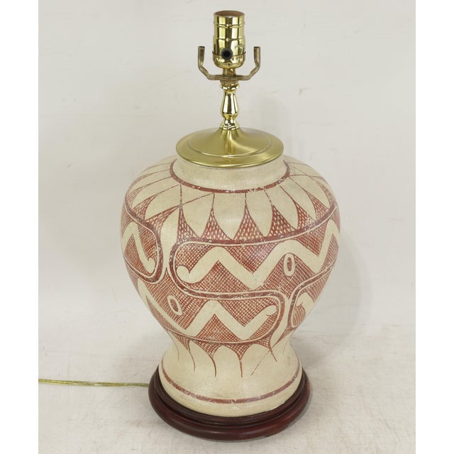 This striking vintage ceramic table lamp features exquisite hand-painted tribal-style patterns, adorned with delicate...