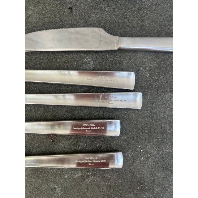 32 piece stainless steel flatware pieces manufactured by Robert Welch. The pattern is Svenska and the set consists of: 10...
