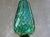 This elegant hand-blown art glass vase is distinguished by its elongated, tulip-inspired silhouette and luminous emerald...