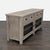 This Pottery Barn media console features a rustic wood finish, two spacious drawers, and two glass-front cabinets with...