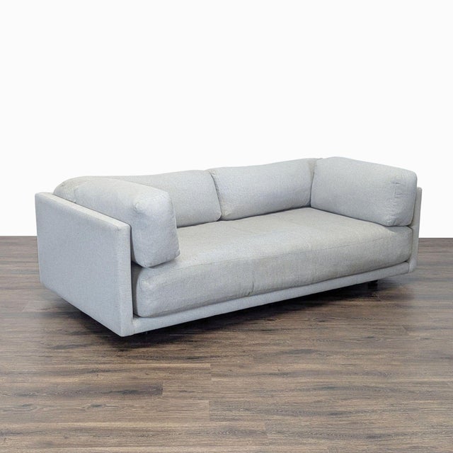 This BluDot 3-seat sofa is stylish and comfortable, featuring a clean, modern design with soft light grey fabric. The...