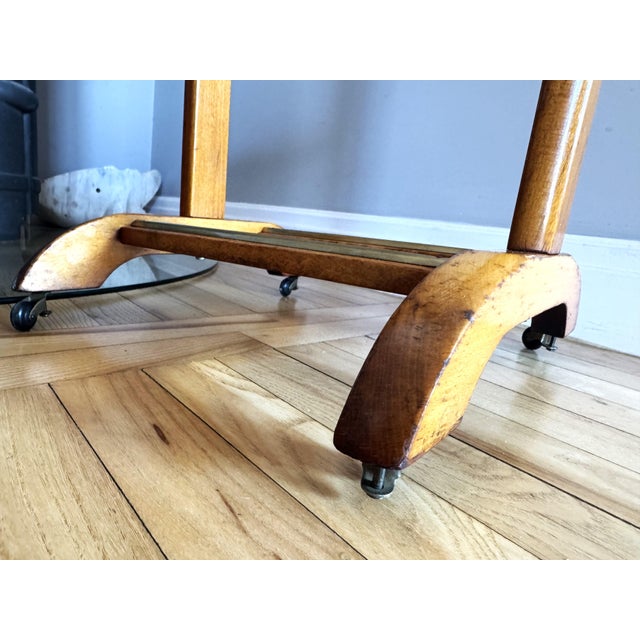 Elegant Italian valet stand by Fratelli Reguitti, crafted in solid wood with brass accents and classic mid-century...