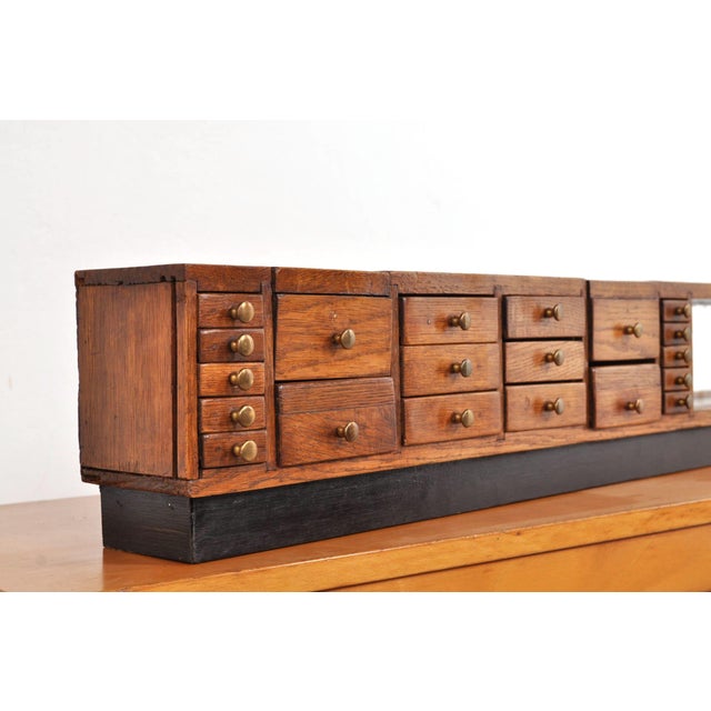 A truly unique haberdashery cabinet! this antique shop display case from around 1910 is handcrafted from oak and...