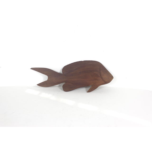 Very cool and rustic, hand carved fish sculpture with a hole on the back so you can easily hang it on your wall. Very good...