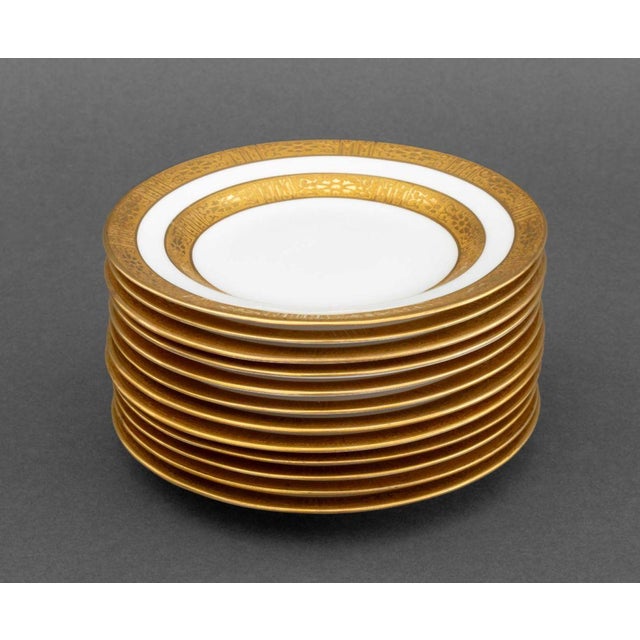 Set of Twelve Ovington Brothers Gilt Encrusted Porcelain Bread Plates, each marked "England / Ovington Brothers" to...