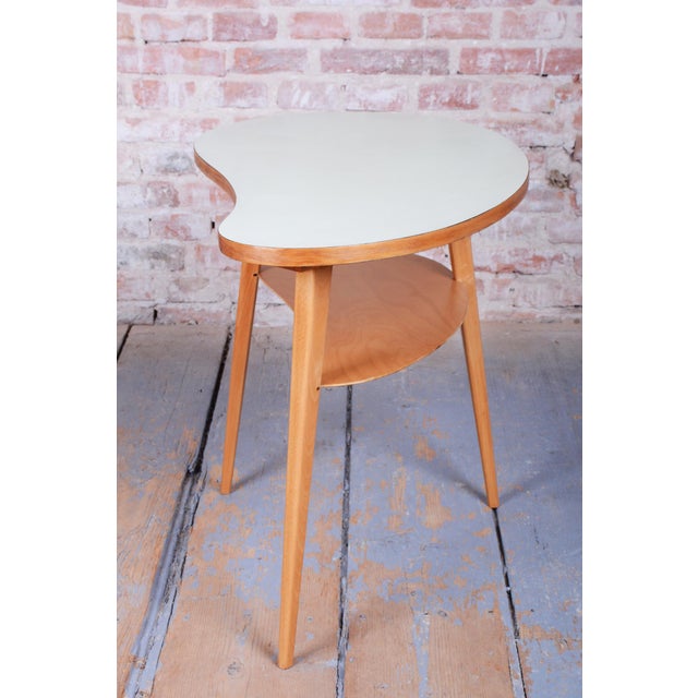 This elegant side table dates back to the 1950s and represents an iconic example of Czechoslovak "Mid-Century" design. The...