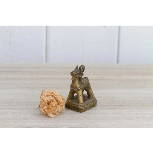 Handcrafted using glistening brass, this petite statuette features a man riding a horse embellished with brass casted...