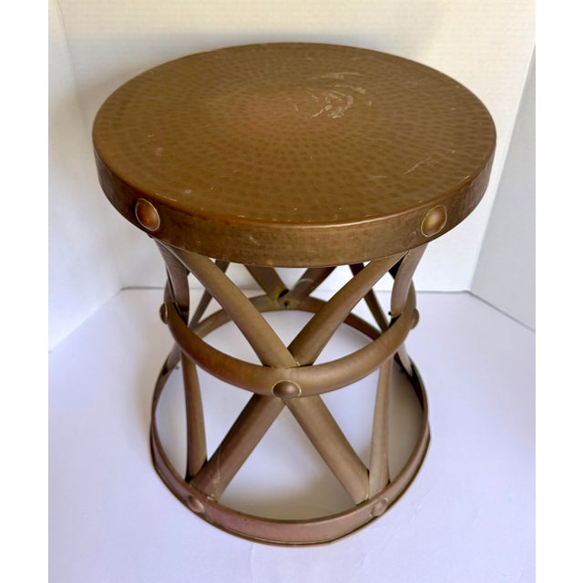 Here is a great vintage hammered brass stool, likely made in the 1970s. This piece features a sculptural X-form base with...