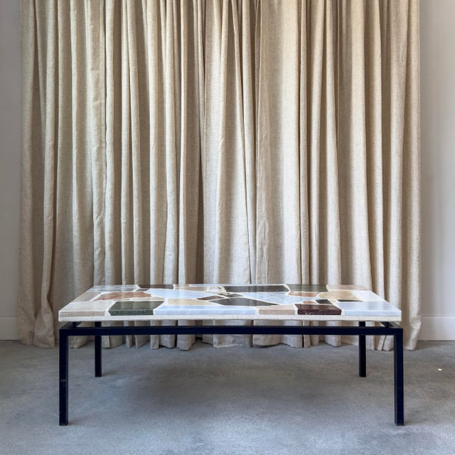 Marble top coffee table, 1960s. The rectangular table features a marble and slate terrazzo stone top in varying in green,...
