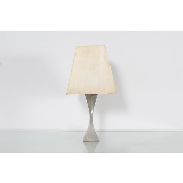 Stylish single light table lamp with nickel-plated brass base made up of two triangular pyramids, each slightly twisted,...