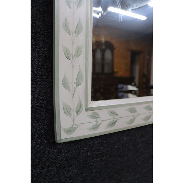 Charming painted wood mirror attributed to The Kellogg Collection, featuring a hand-painted botanical vine and leaf motif...