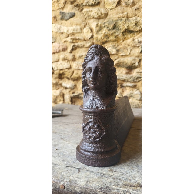 Pair of 19th-century cast iron andirons. Height 19 cm. Width 8.5 cm. Depth 36 cm. Signs of wear and age / The andirons...