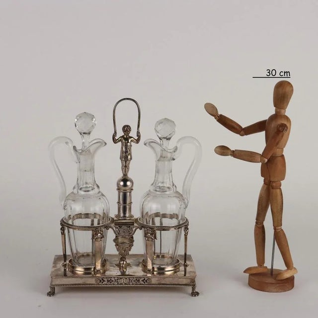 Molten, embossed and chiseled silver vinegar bottles, non-coeval cut crystal ampoules. Paris, master goldsmith “SJ...