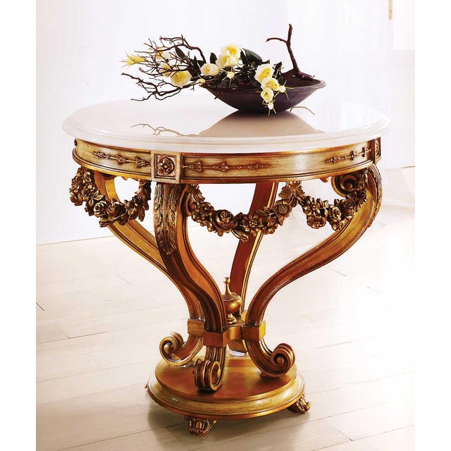 Handcrafted in Italy, this center table is made from solid wood and features exquisite hand-carved swags that exemplify...