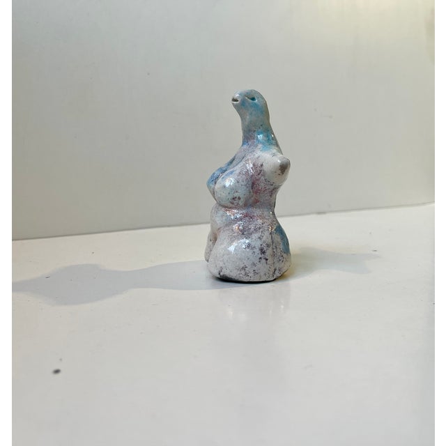 A unusual scandinavian studio-piece in the shape of this plumpish female torso with lizard head and neck. Unknown ceramist...