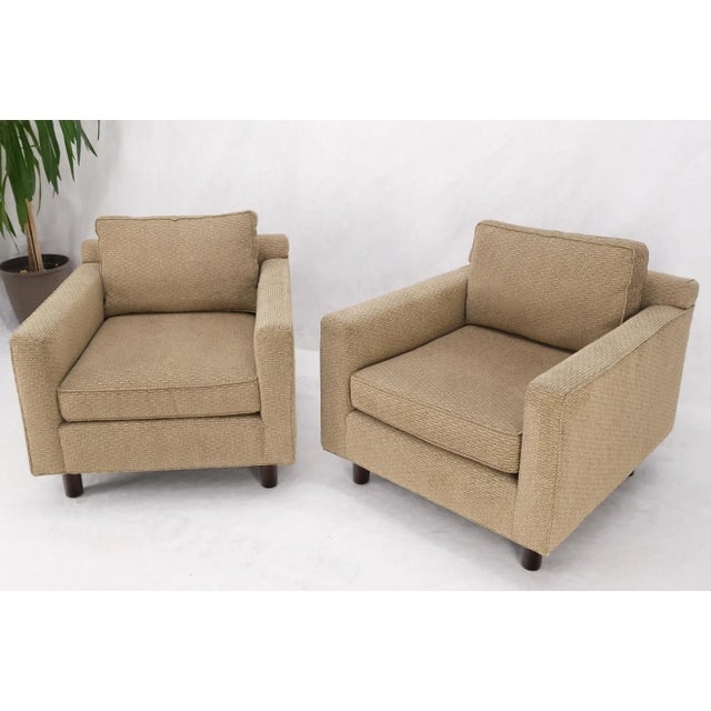 Pair of deep oatmeal fabric upholstery contemporary lounge chair on dowel legs.