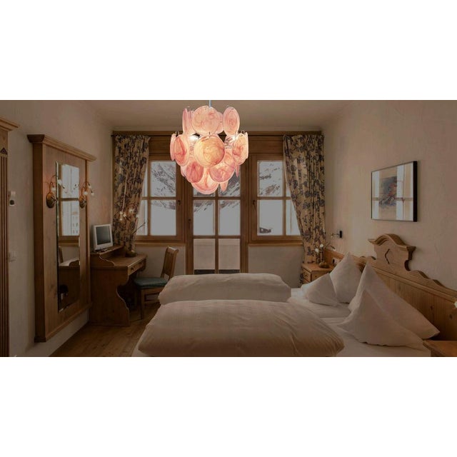 Vintage Italian Murano chandelier in Vistosi style. The chandelier has 24 fantastic iridescent alabaster pink discs in a...