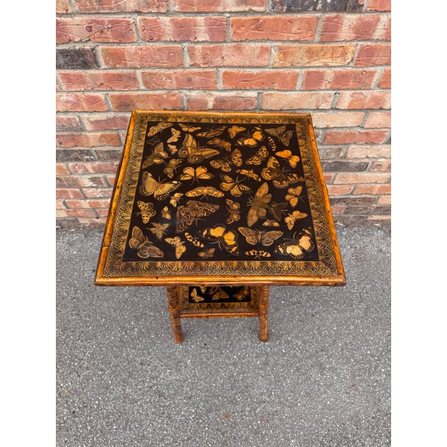 This 19th Century English Bamboo Side table features a delightful variety of butterflies decoupaged onto the top and lower...