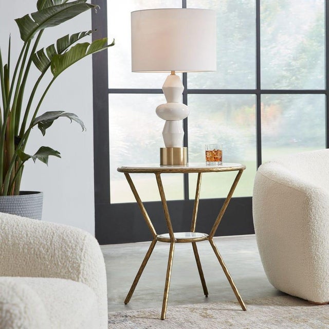 This elegant marble top and textural metal base create a dynamic combo! This table is crafted with a solid chiseled iron...