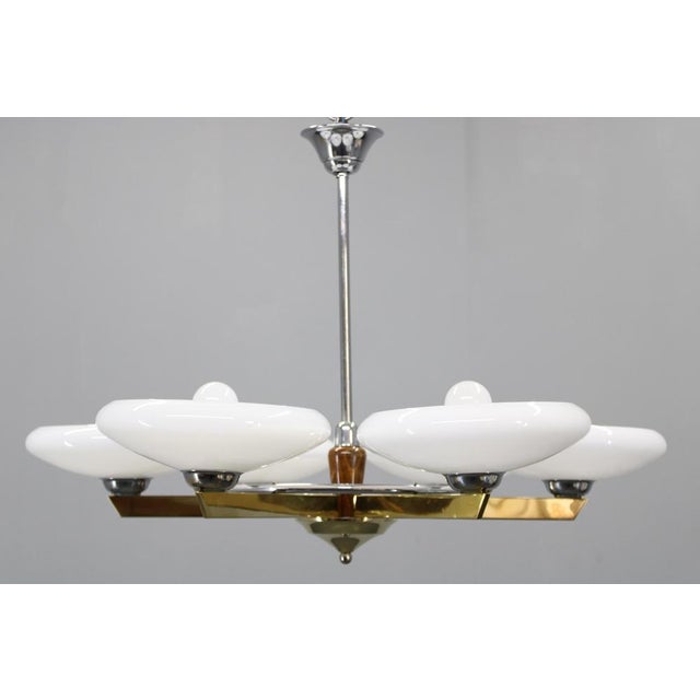 This elegant Art Deco chandelier originates from Czechoslovakia, 1940s, and showcases a refined blend of chromed metal,...
