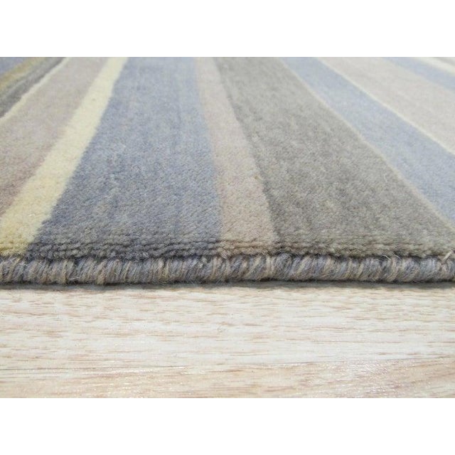 This blue wool rug features a hand knotted pile construction designed for reliable performance and lasting quality....