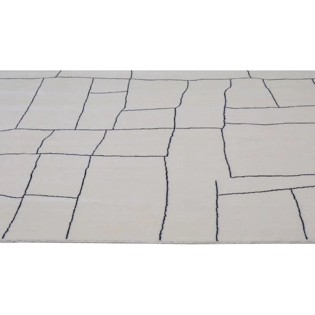 Moroccan Azilal hand knotted wool rug with abstract design.