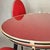 Elegant set of a table and four matching red chairs by Umberto Mascagni, designed in the 1950s. The wooden table frame...