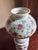 Mid century miniature “Gone with the Wind” style oil lamp with milk glass construction. Opaque white glass with hand-...