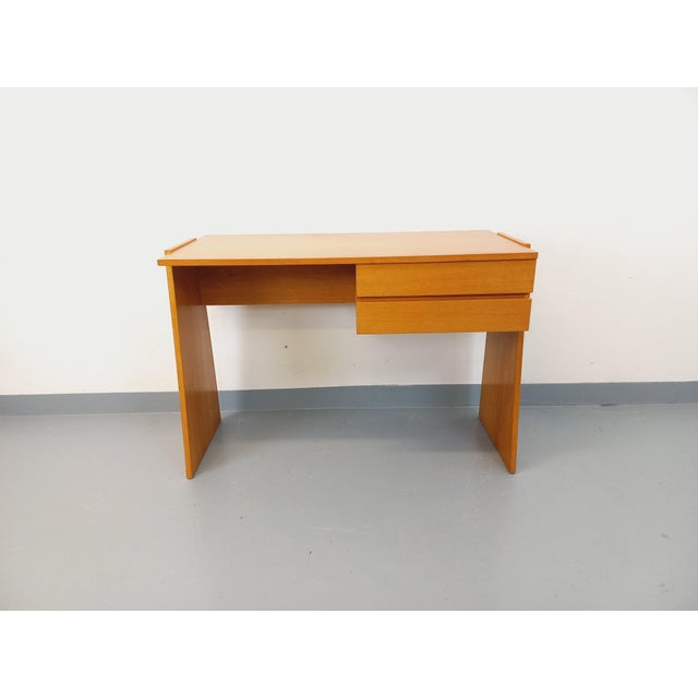 Vintage 1960s double-sided desk, perfect for the center of a room. Stunning design with unique trapezoidal legs extending...