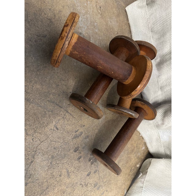 Antique set of four American made fabric textile wooden spoils.