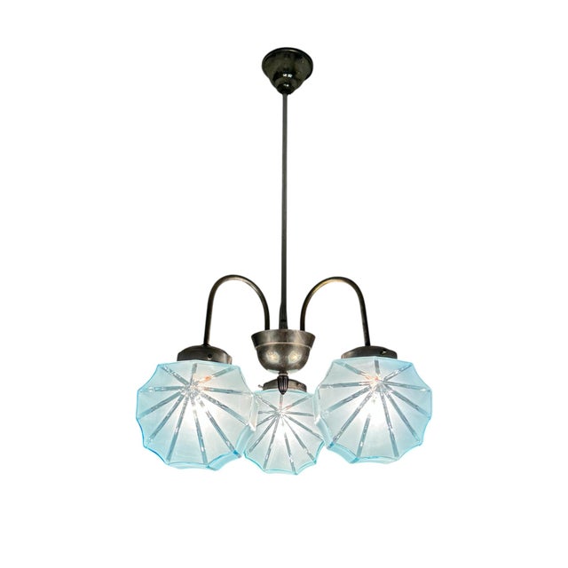 Splendid and very rare Art Deco chandelier, Central Europe 1930s. Nickel plated body with 3 arched arms holding scalloped...