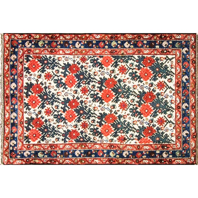 A beautiful and finely woven antique Persian Bakhtiari rug featuring a rare and highly decorative all-over floral design...