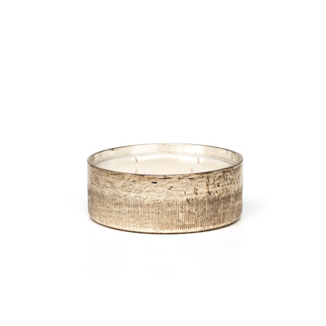 In addition to the charmed, rustic shape of this candle jar, antique gold applied to the surface creates an occasional...