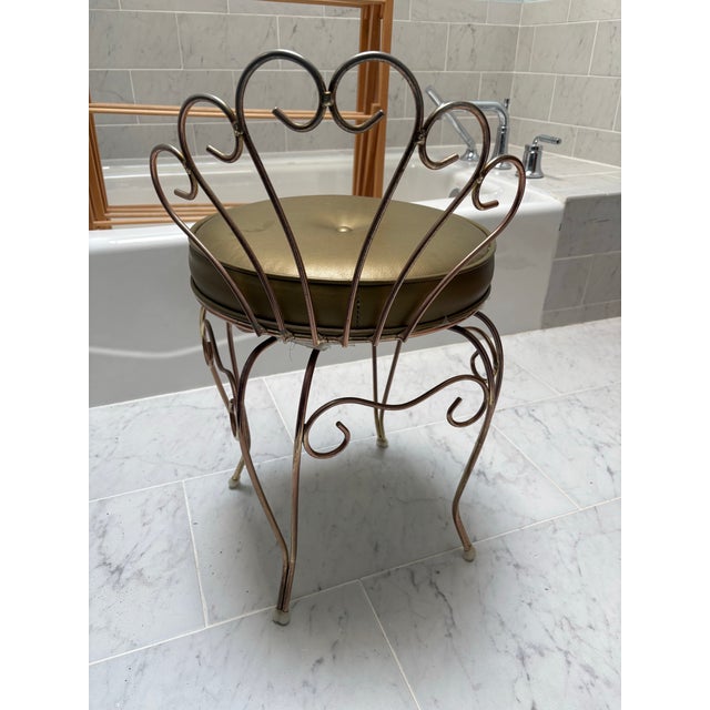 Vintage vanity stool in brass with gold vinyl cushion. Bought in the 1970s. Dimensions: 14” wide x 14” deep x 25” tall...