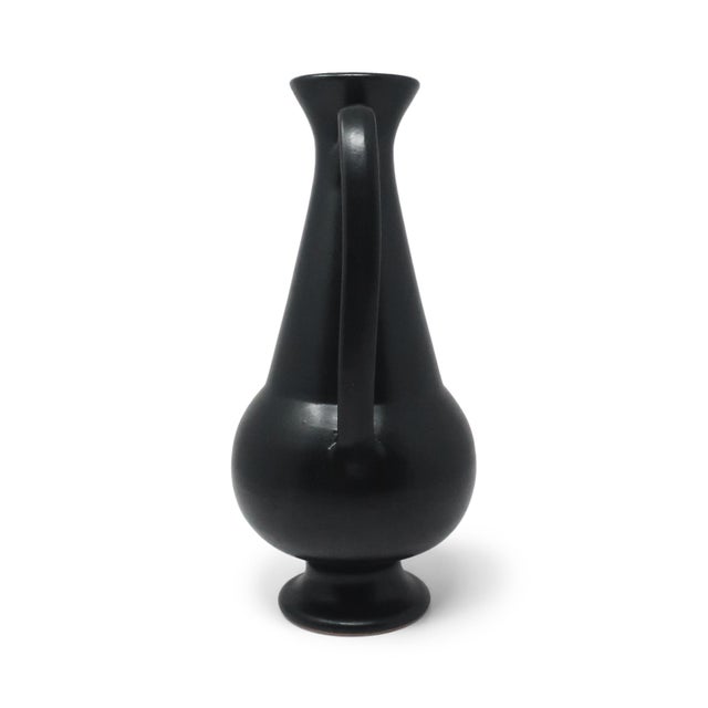 A two-handled amphora in black bucchero ceramic, designed by Gio Ponti and produced by Neoponti/Costantino, Italy, 1997. A...