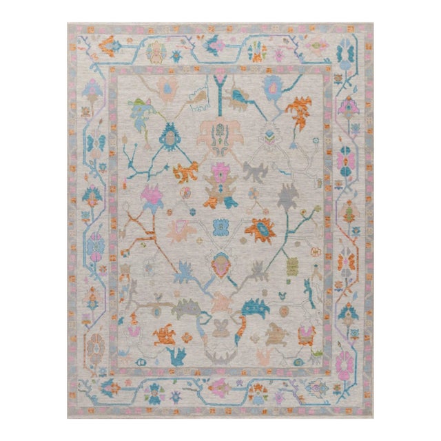 Colorful blue, pink, orange modern handknotted oushak rug As all of our rugs are made by hand, each may have slight...