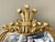 An ornate gilt framed wooden mirror with an elaborate Rococo-style carved Prince of Wales decorative crest and floral...