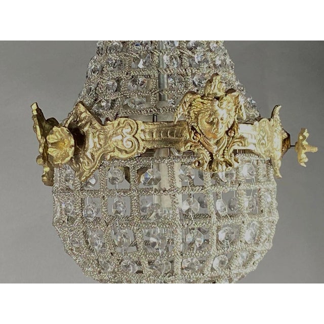 A charming 1980s French Louis XVI–style petit chandelier, crafted in bronze with a warm gold finish. Compact yet highly...