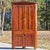 This is a stately and highly desirable antique Corner Cupboard that beautifully exemplifies the Country Federal or Federal...