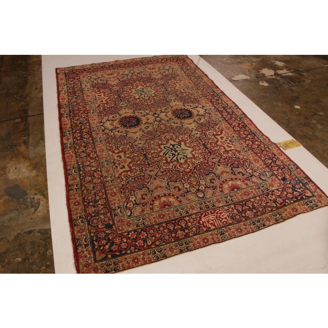 Hand knotted in wool originating circa 1890-1900, this antique Persian rug, whose origins lie in the celebrated Kerman...