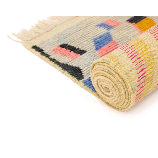 This hand-knotted wool runner rug by Azele Studio features a bold geometric composition structured in dynamic vertical...