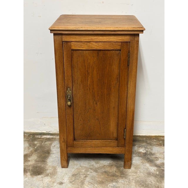 This antique English oak pot cupboard nightstand is a beautifully simple yet refined piece, showcasing the timeless...