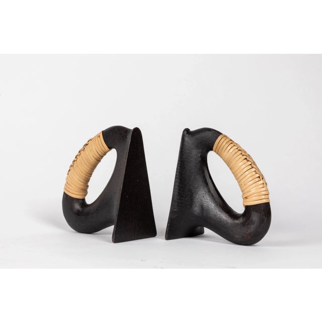 Pair of Carl Auböck model #3530 'Flatiron' patinated brass and cane bookends. Designed in the 1950s, this incredibly...