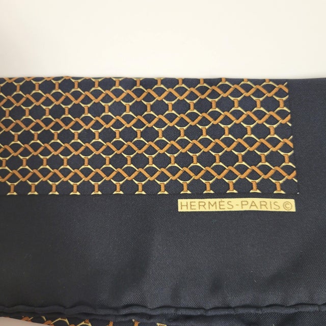 Enhance your wardrobe with this exquisite Hermès Paris silk scarf, a versatile treasure that works beautifully as a neck...