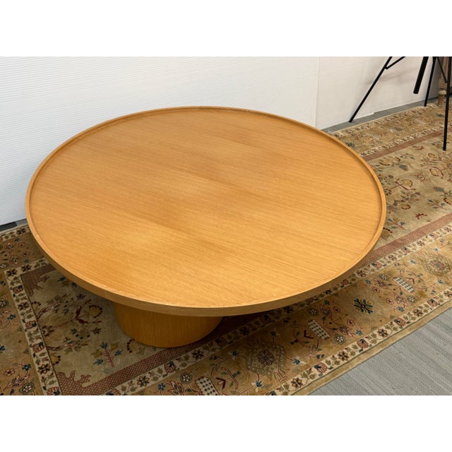 Design Plus Gallery presents a Bespoke Coffee Table. This piece has a circular top with a raised edge and three...