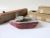 Collection of 3 vintage handmade and carved toys. Sleek gray train on metal washer wheels, painted wood tug boat with...